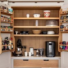 an organized pantry with coffee maker, cups and other kitchen items on the counter top