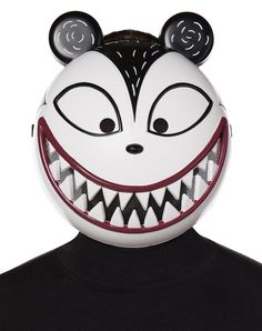 a person wearing a mickey mouse mask with big eyes and fangs on their face,