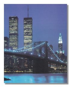 an image of a city at night with the brooklyn bridge in the foreground and skyscrapers lit up