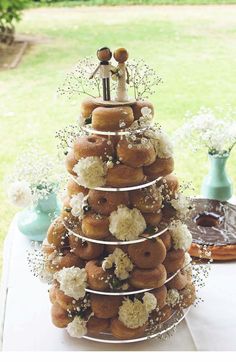 a wedding cake made out of doughnuts and flowers