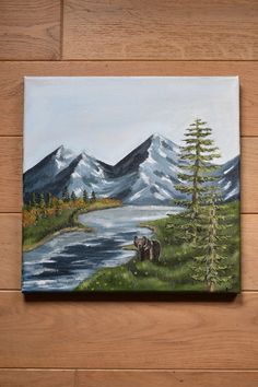 a painting of a bear on the side of a mountain lake