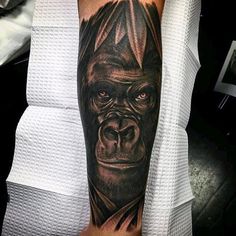 a man's arm with a gorilla tattoo on it