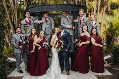 a group of people standing next to each other in front of a gazebo at a wedding