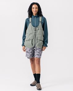 The Takibi Weather Cloth Vest is a fire-resistant utility vest. The vest features adjustable straps with metal buckle closures, a zip front with a chest snap, dual oversized pouch pockets with hook-and-loop secured envelope flaps, dual side loops, oversized back storage pouches, and an additional storage loop at the curved hem. The Takibi Vest is designed to fit loose on the body with the hem hitting below the waist. We recommend taking your normal size for an oversized fit. The model stands 6' Utility Vest, Storage Pouch, Recycle Plastic Bottles, Metal Buckles, Recycled Plastic, Pocket Pouch, Quick Dry, Elastic Waist, Adjustable Straps