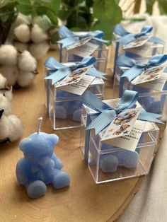 small clear boxes with blue candies in them and a teddy bear on the side