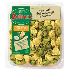 a package of pasta with green sauce and tomatoes