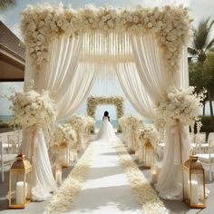 a bride and groom are standing under an archway decorated with flowers, candles and white drapes