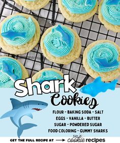 some cookies with blue icing are on a cooling rack and there is an advertisement for shark cookies