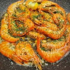 cooked shrimp with herbs and seasoning in a skillet