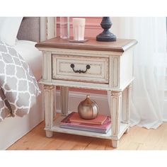 a nightstand table with two drawers and a vase on top