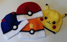 three crocheted hats with pikachu and pokeball on them sitting next to each other