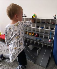 a toddler playing with toys in a playroom