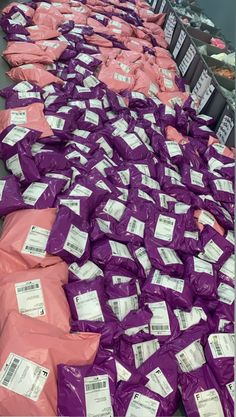 purple bags are stacked on top of each other in the middle of a room filled with boxes