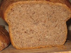 a loaf of bread sitting on top of a wooden cutting board