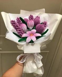 a person holding a bouquet of flowers in their hand