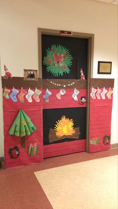 a fire place with christmas decorations on the front and back doors, decorated in red brick