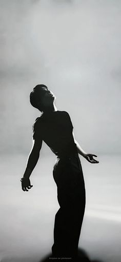 a black and white photo of a woman in silhouette