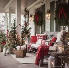 a porch decorated for christmas with red and white decorations