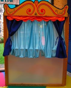 an old fashioned carnival booth with blue curtains