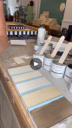 some paint cans are sitting on a table