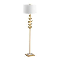 a gold floor lamp with a white shade