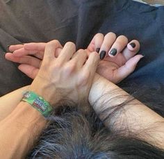 two people with their hands on top of each other