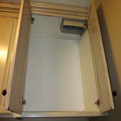 an empty cabinet in the corner of a kitchen