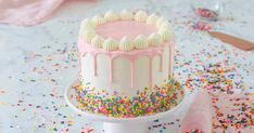 a birthday cake with sprinkles and pink frosting