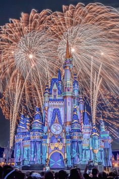 fireworks light up the night sky over cinderella's castle