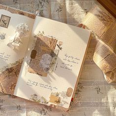 an open book on a table with some papers and tape attached to the pages that have been altered