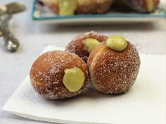 three donuts covered in icing sitting on top of a napkin