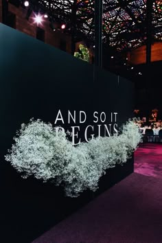 the words and sot begins are displayed on a black wall in front of a purple carpet