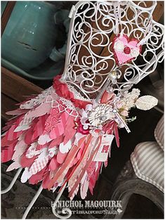 a white chair with pink flowers and hearts on it