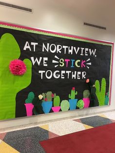 a bulletin board that says at northview, we stick together with cactus and flowers