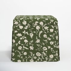 a green and white flowered box sitting on top of a table