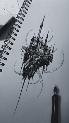 a drawing of a castle on top of a book next to a pen and ink