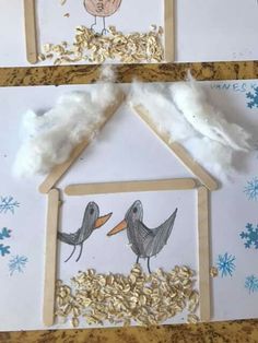 two bird houses made out of popsicle sticks and some cotton on the table next to each other