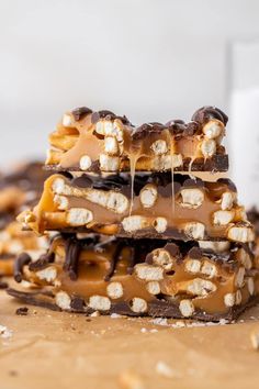 three pieces of chocolate and marshmallow barkle stacked on top of each other