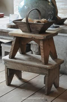 an old wooden bench with a basket on it