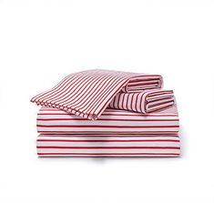 red and white striped sheets folded on top of each other in front of a white background