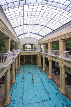 an indoor swimming pool with people in it