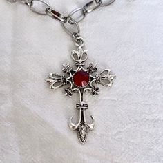 This silver gothic cross necklace boasts a vintage cross pendant, featuring grunge jewelry aesthetics, presenting a statement red cross necklace that's an ideal religious jewelry gift idea for her, especially for those who appreciate distinctive and edgy accessories. 𝐃𝐄𝐓𝐀𝐈𝐋𝐒:  ⭐️ Necklace length is 16" ⭐️ Pendant size is 1 15/16" x 2 1/8" ⭐️ The silver cross pendant is silver plated over alloy. The chain necklace is up on stainless steel, safe for those with sensitive skin ⭐️ The best sta Red Gothic Cross Necklace, Gothic Cross Jewelry Gift, Gothic Cross Jewelry As Gift, Gothic Cross Jewelry For Gifts, Gothic Cross Necklace Gift, Gothic Crucifix Cross Necklace As Gift, Gothic Crucifix Cross Necklace For Gift, Red Cross Pendant Necklace Gift, Red Cross Pendant Necklace For Gift