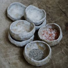 five bowls with different types of spices in them