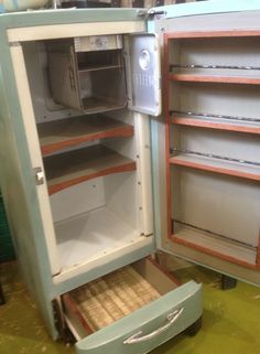 an old fashioned refrigerator with its door open