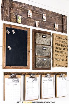 a bulletin board and calendars are hanging on the wall in front of a wooden frame