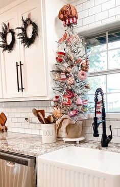 a christmas tree in the corner of a kitchen