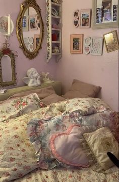 a bedroom with pink walls and pictures on the wall