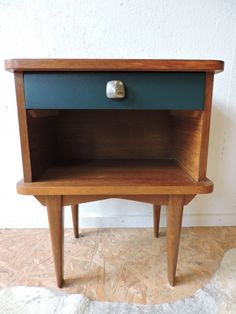 a small wooden table with a drawer on the top and one drawer open to reveal something