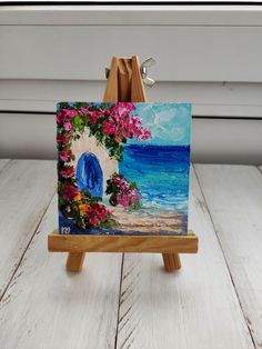 a small easel with a painting on it