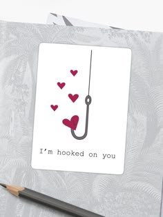 i'm hooked on you card with pencil next to it and an image of a fishing hook